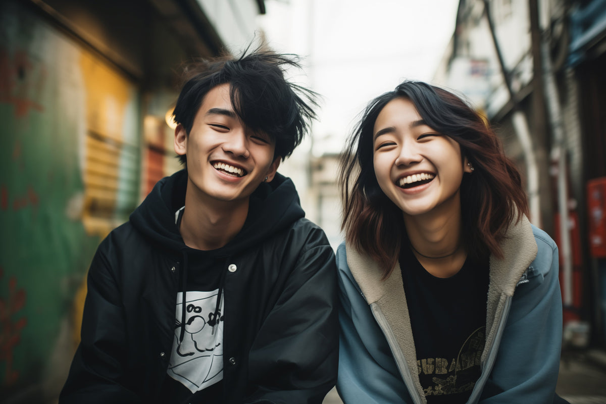 Two laughing Japanese students on a city street, the kind of learners JET Programme teachers work with