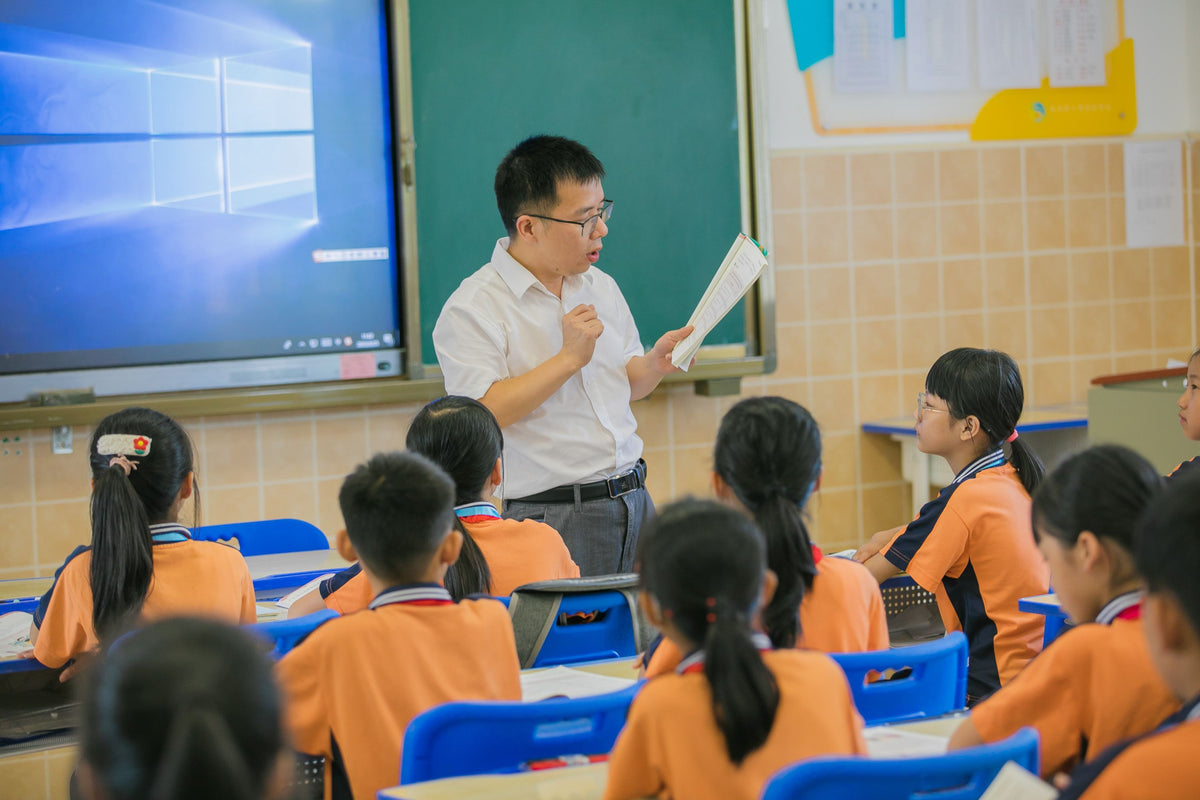 English teacher leading a small class of children at a Korean hagwon academy