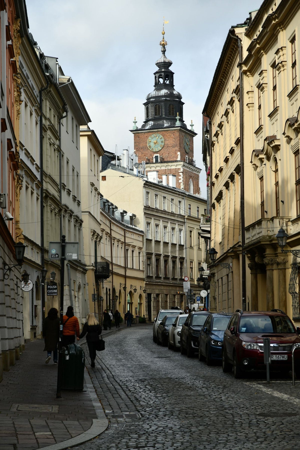 Cobblestone street and town hall tower in Krakow Poland old town where many TEFL teachers live