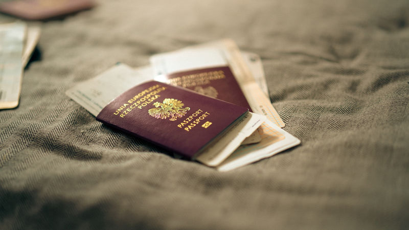 US passport and travel documents laid out for a visa application to teach English in Europe