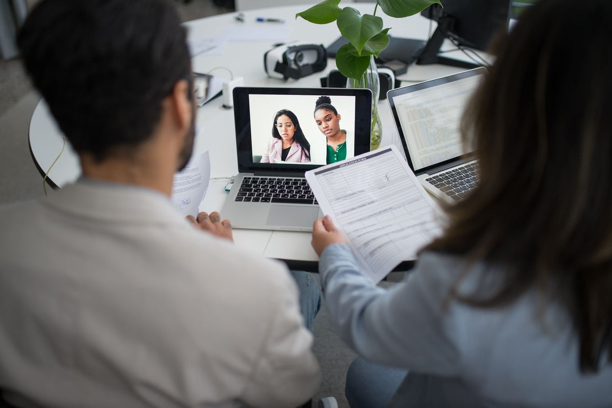 Remote English teacher preparing for an online job interview with a laptop