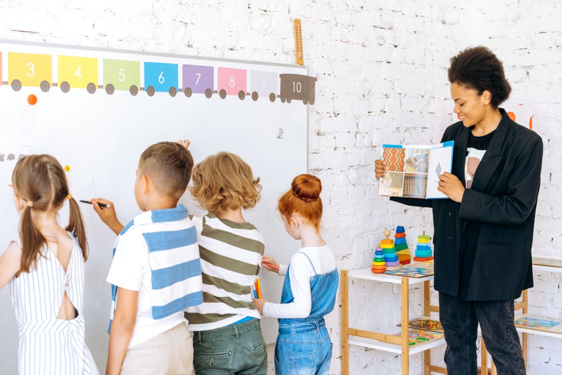 Teacher working with students in a classroom, similar to a NALCAP Spain language assistant placement