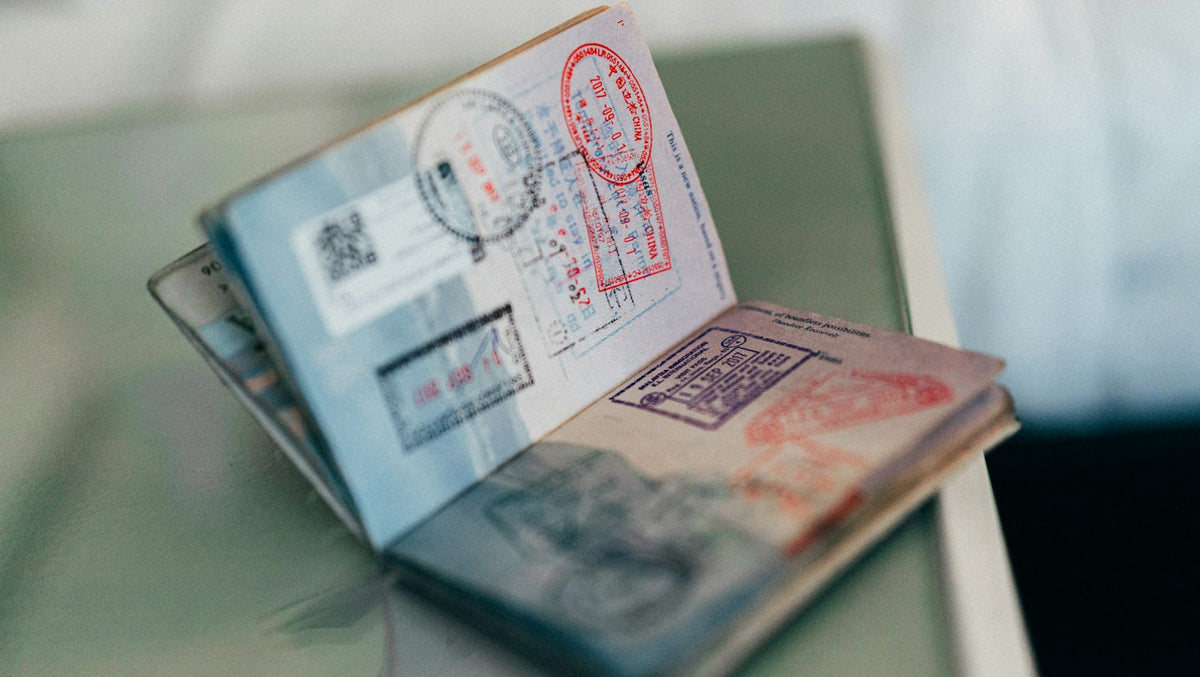Passport filled with entry stamps ready for a Portugal D7 or D8 visa application by an English teacher