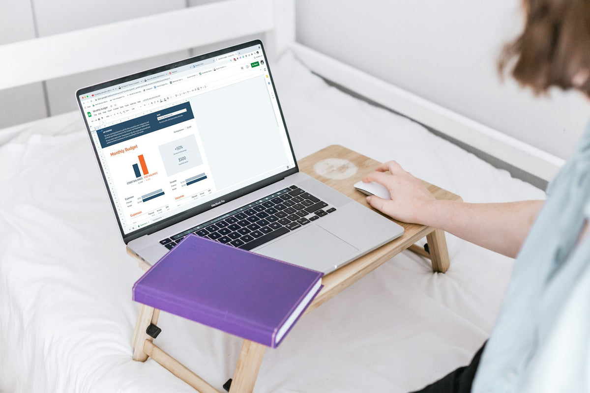 Student planning TEFL certification costs with a laptop, notebook and budget sheet