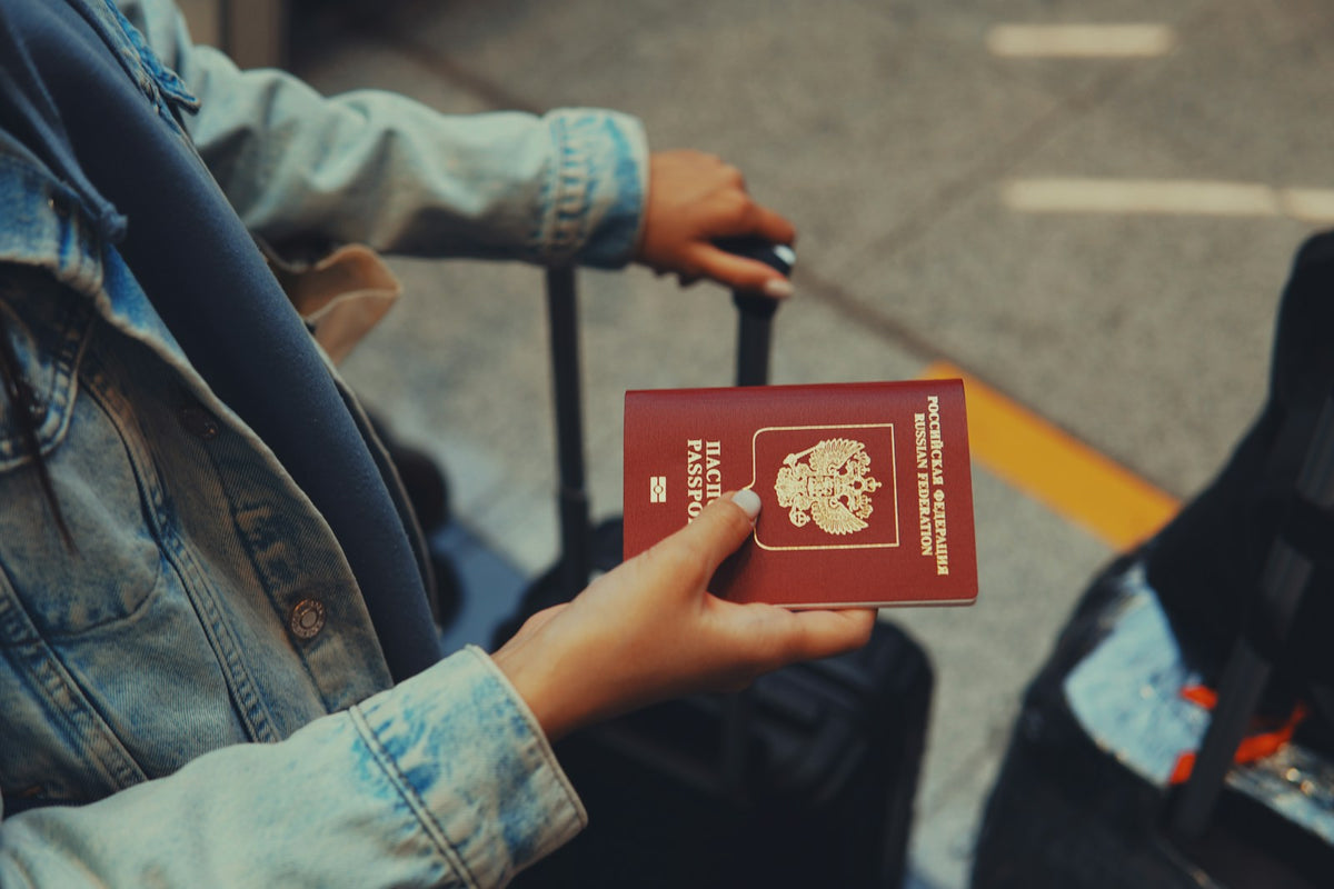 Person holding a US passport, representing the visa paperwork behind TEFL jobs for Americans
