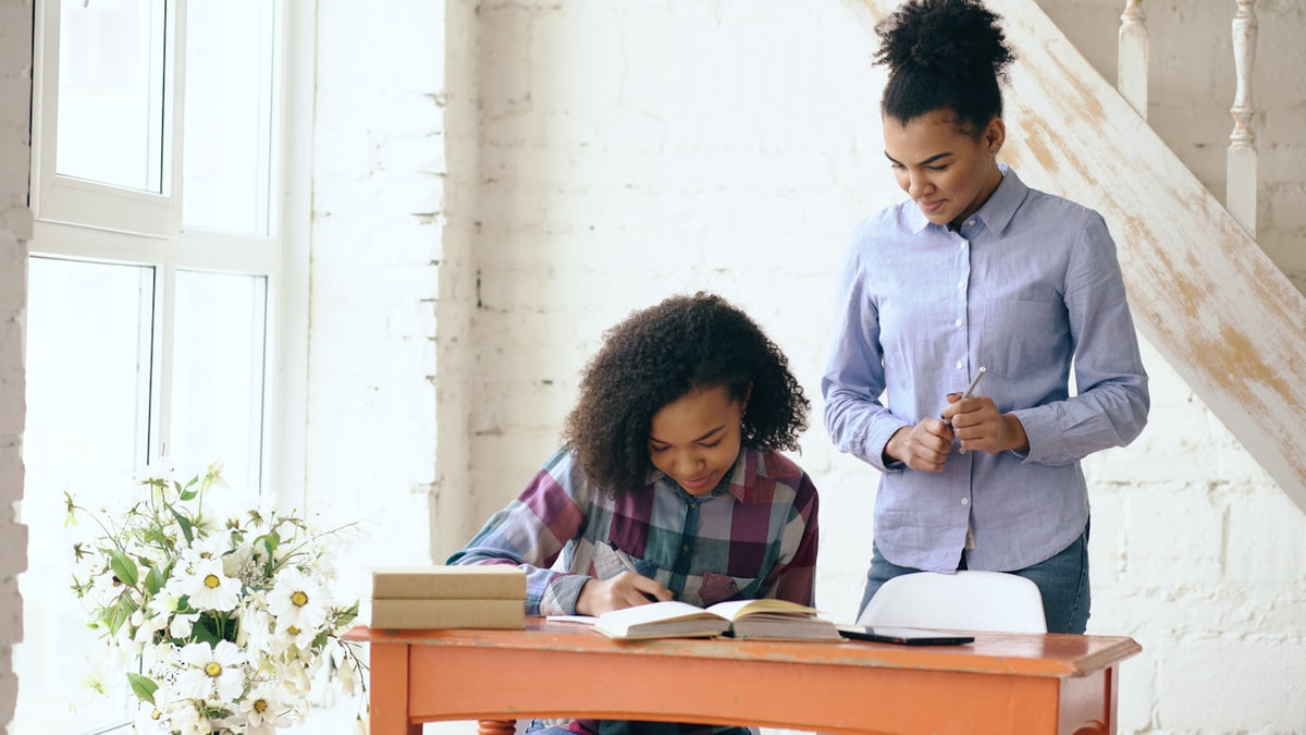 Private English tutor working one on one with a student at a desk