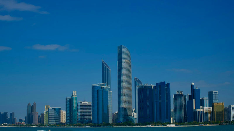 Modern skyscrapers above the sea in a Gulf city, where English teachers work in international schools across the Middle East