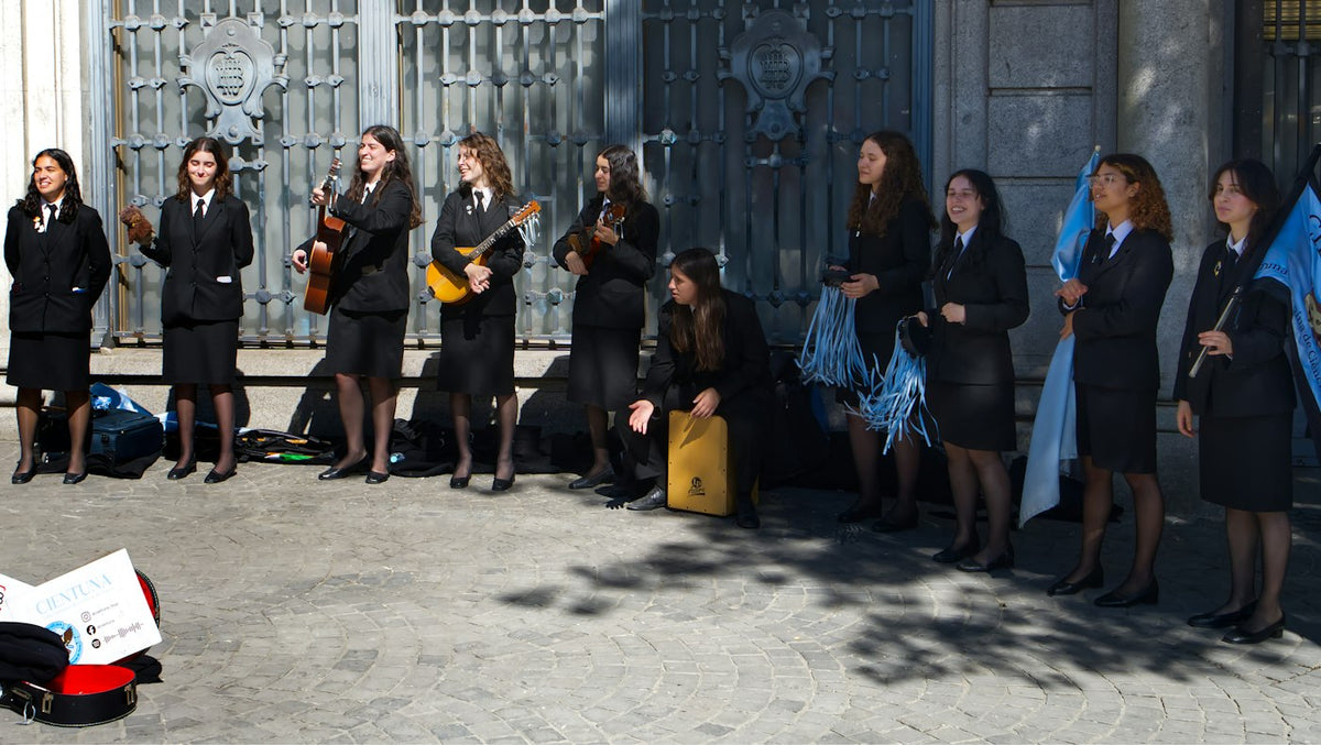 University students in traditional academic dress in Porto Portugal where English teachers find private school work