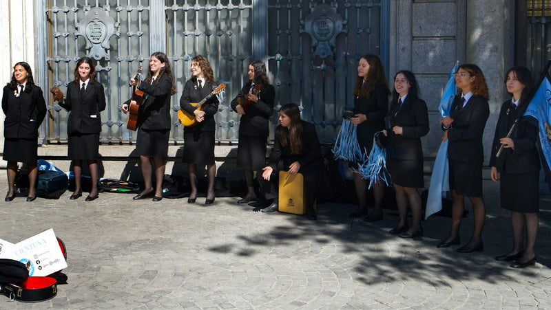University students in traditional academic dress in Porto Portugal where English teachers find private school work