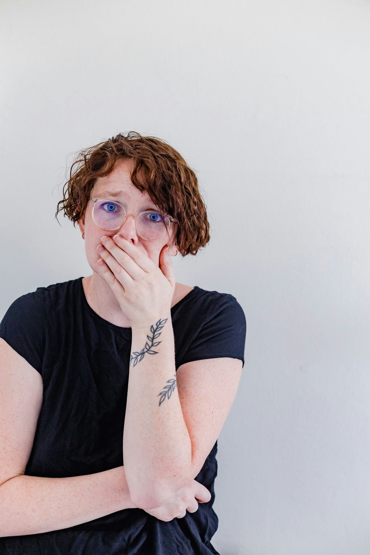 Worried student covering her mouth after spotting red flags while reading TEFL course reviews