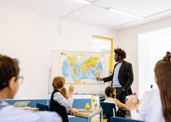 Business English teacher delivering professional communication training to learners preparing for international workplaces