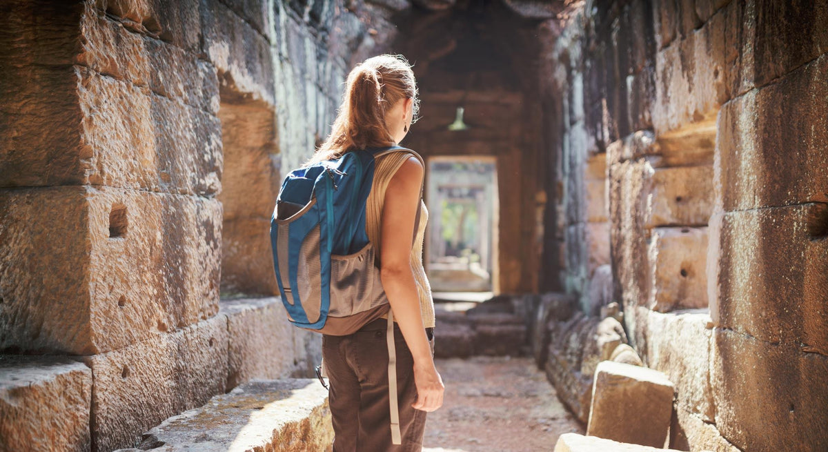 A woman standing in a Cambodian temple