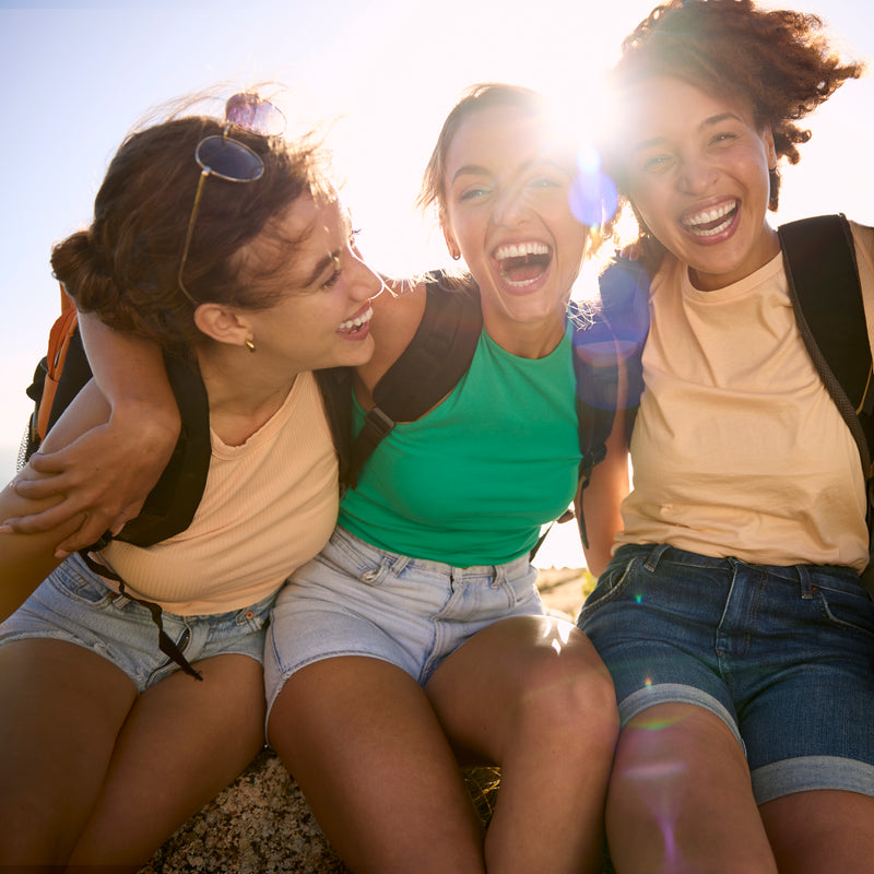 Three Women Laughing While Hiking on Sunny Day 2026 03 10 04 02 09