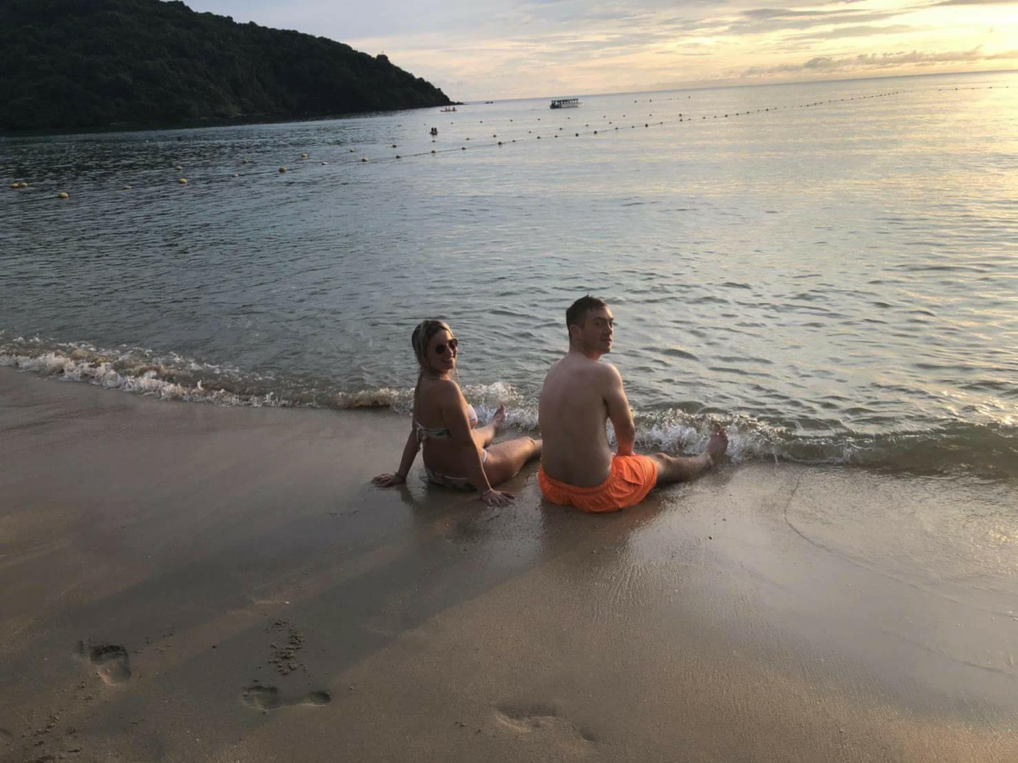 Keith and Roksana sitting on the beach