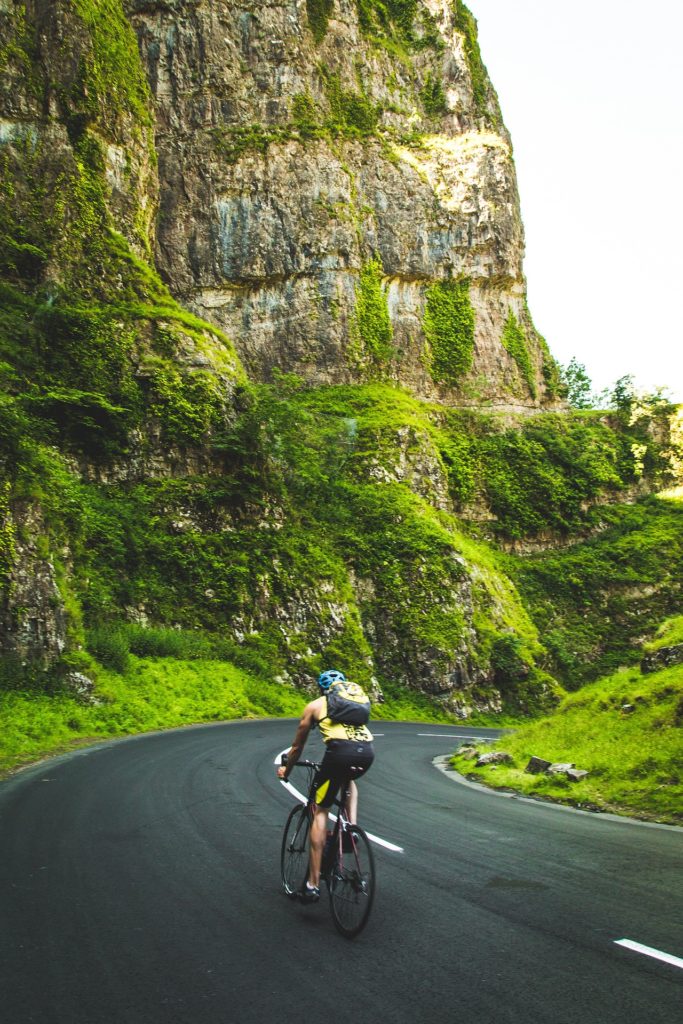 A man cycling through the hills
