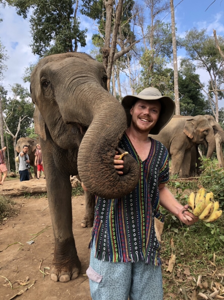 Sean taking a picture with an elephant. 