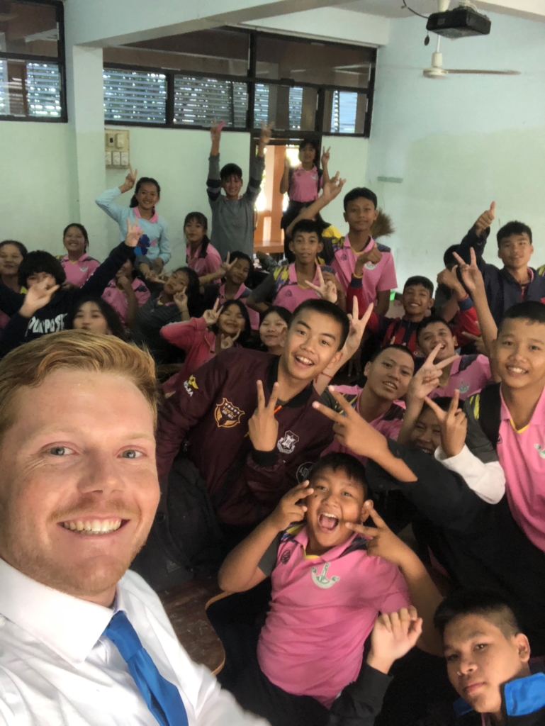 Sean taking a selfie with his students.