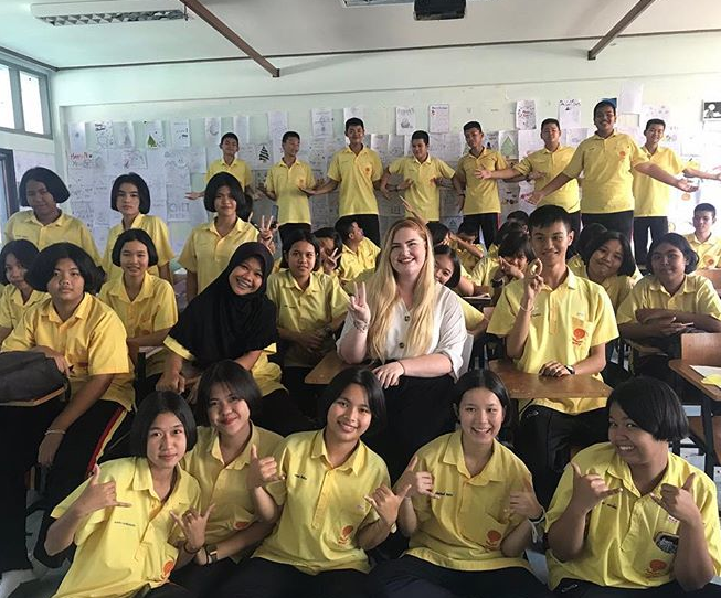 Stephanie taking a picture with her students.