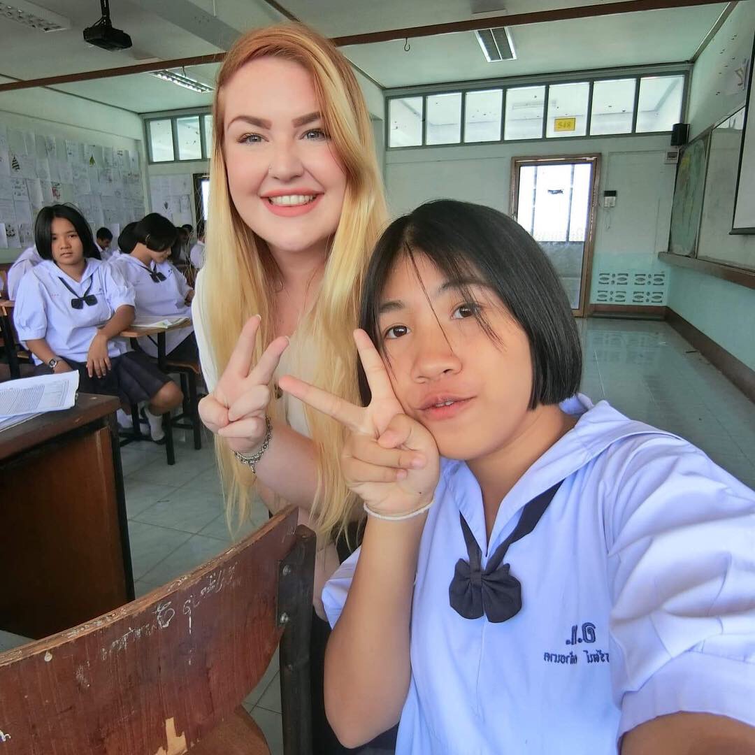 Stephanie taking a picture with one of her student.