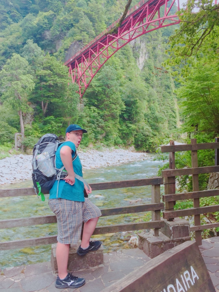 Sheldon hiking through Japanese countryside.