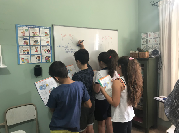 Argentinian students writing on a white board. - Teaching English in Argentina