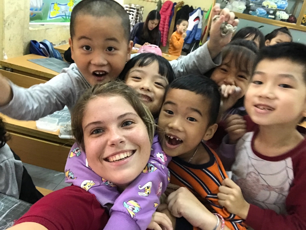 Emma taking a selfie with her students.