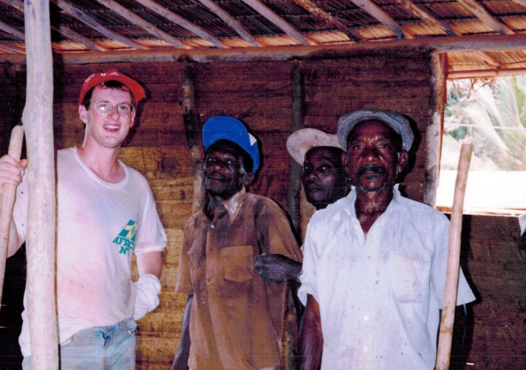 Peter standing with men - TEFL in Africa