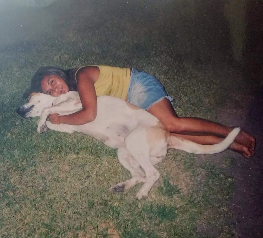 Lorena lying down with a dog