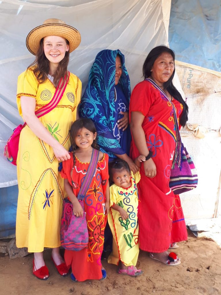 Elisabeth pictured with native women and children while doing her TEFL in South America