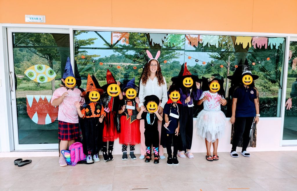 Kyla and her students in Halloween costumes