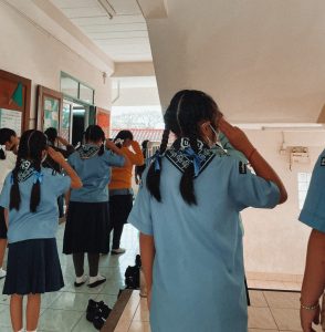 Girls in a Thai school stand for the national anthem