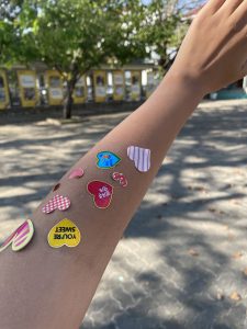 Aneeqa's arm covered in stickers